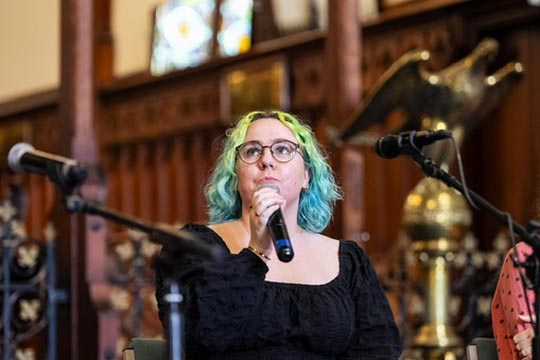 Erin Donohue performing in stage in a Crip the Lit event